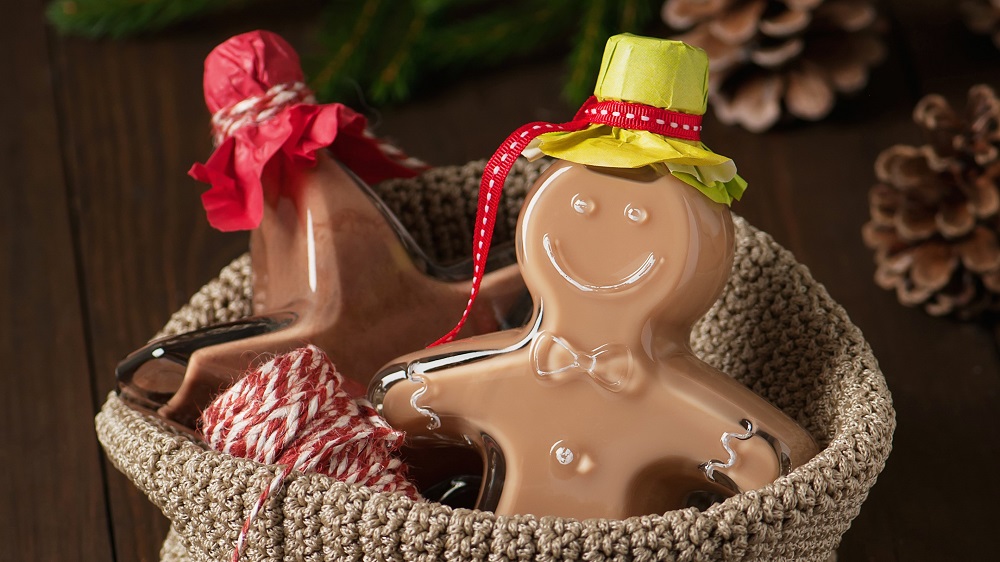 Two bottles with homemade gingerbread and speculoos liqueur as christmas gift.