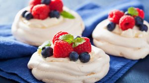 pavlova meringue cake with cream and berry